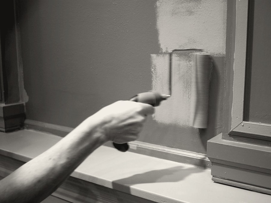 Sample photo: a hand rolling paint onto a wall